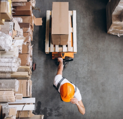 young-man-working-warehouse-with-boxes-min